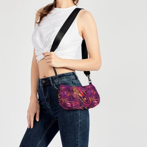 Woman wearing a white crop top, blue jeans, and carrying a colorful handbag on a white background