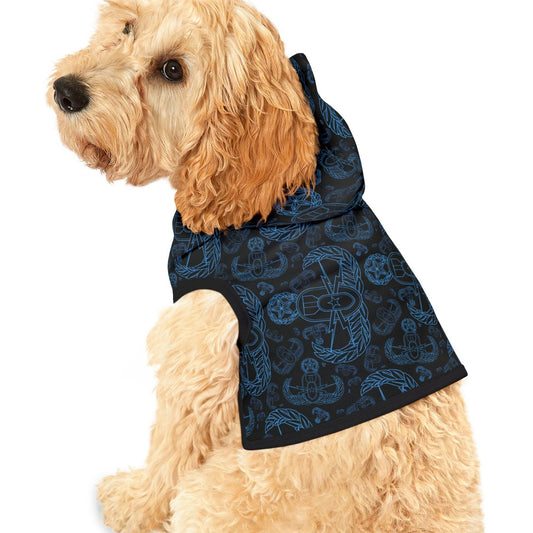 Dog wearing a black patterned coat on a white background