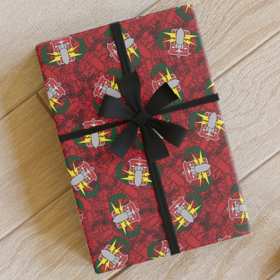 Gift wrapped in red paper with black ribbon on a wooden floor